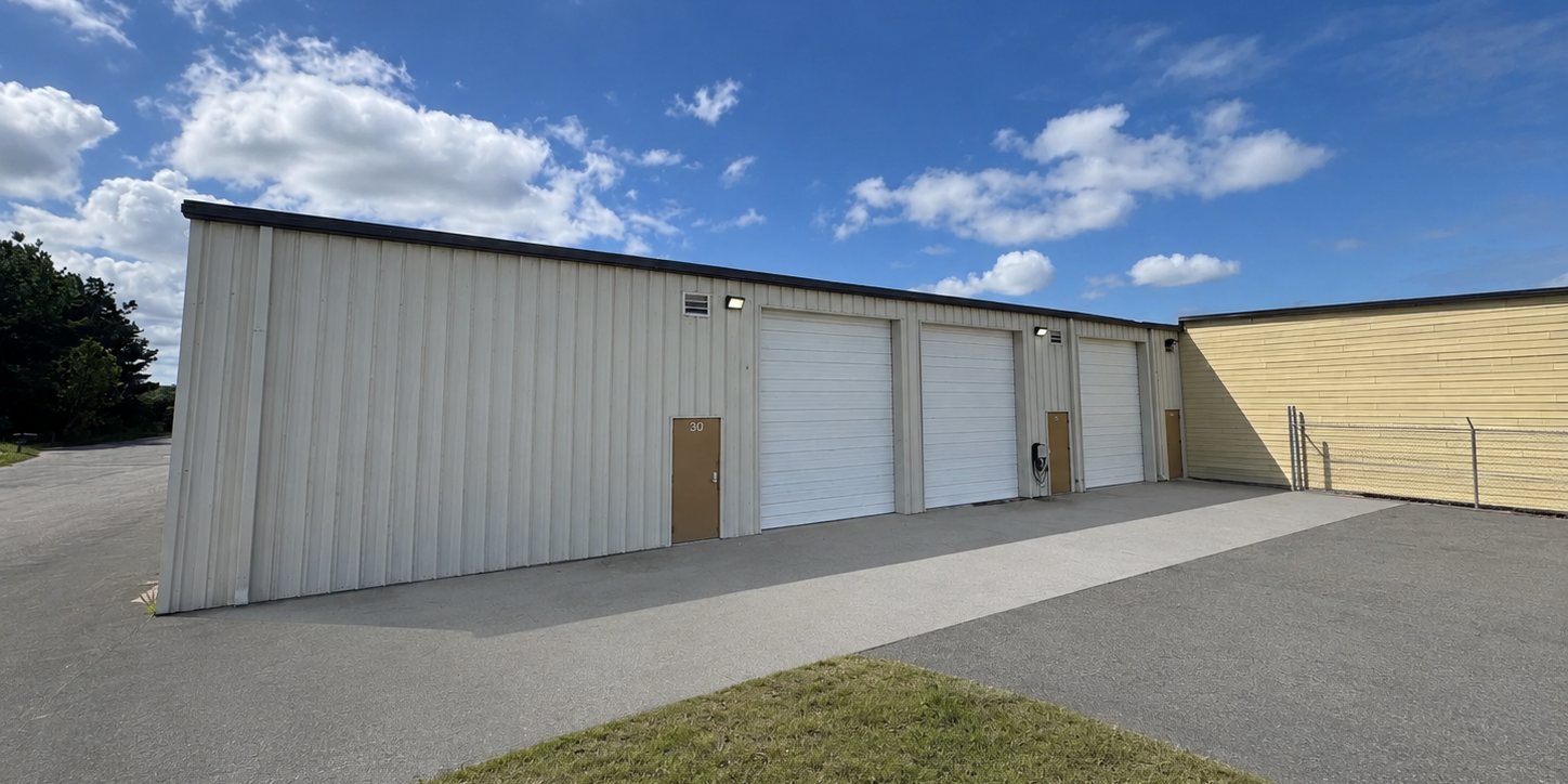 Elevation of 101 Austin Bradley Lane in New Bern, North Carolina, a metal industrial building with three drive-in overhead doors opening onto a paved apron