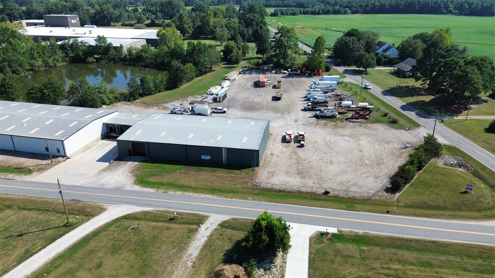 Aerial view of the gravel outdoor storage yard at 4734 Potato House Court beside a green metal warehouse