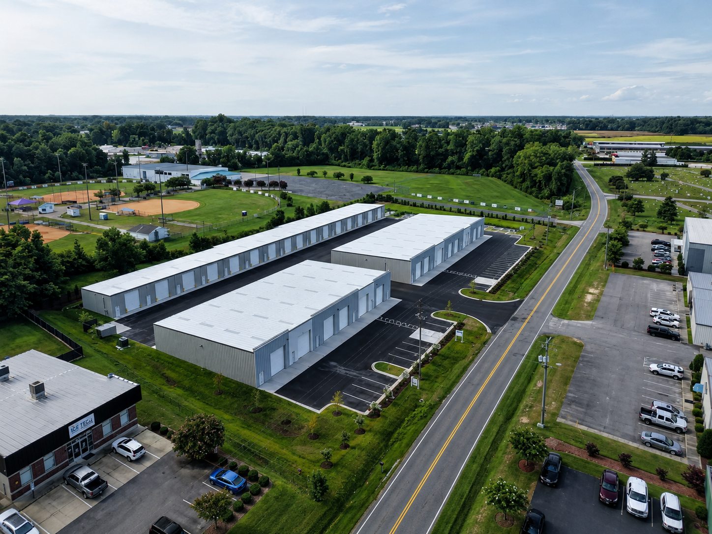 Aerial view of the three flex buildings at Reedy Branch Flex Park, with striped parking and Reedy Branch Road running alongside