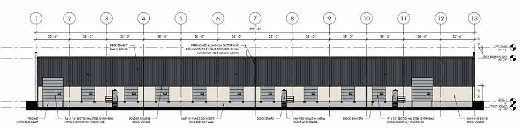 Architectural south elevation drawing across column lines 1 through 13, calling out sectional steel overhead drive-in and dock doors with vision lites, dock stairs, dock bumpers, precast concrete ramp, and cast-in-place concrete foundation wall